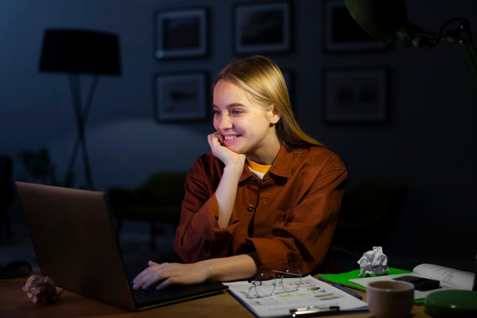 Person reviewing financial documents with calculator and notebook on desk